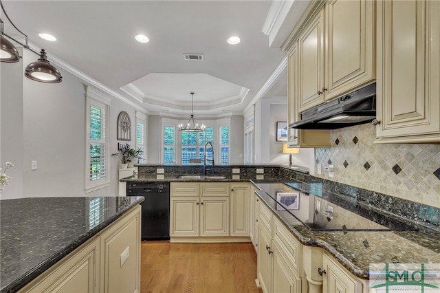 kitchen featuring light hardwood / wood-style floors, sink, black appliances, cream cabinetry, and pendant lighting