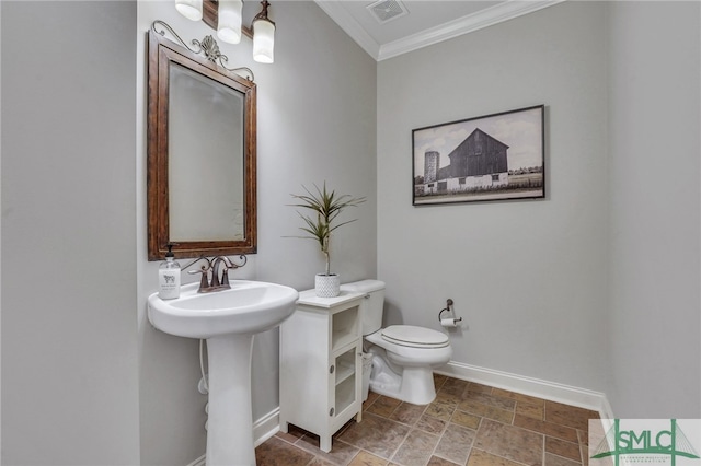 bathroom with crown molding and toilet