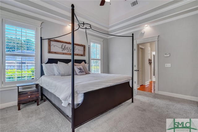 carpeted bedroom featuring crown molding, multiple windows, and ceiling fan