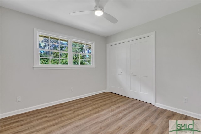 unfurnished bedroom with a closet, ceiling fan, and wood-type flooring