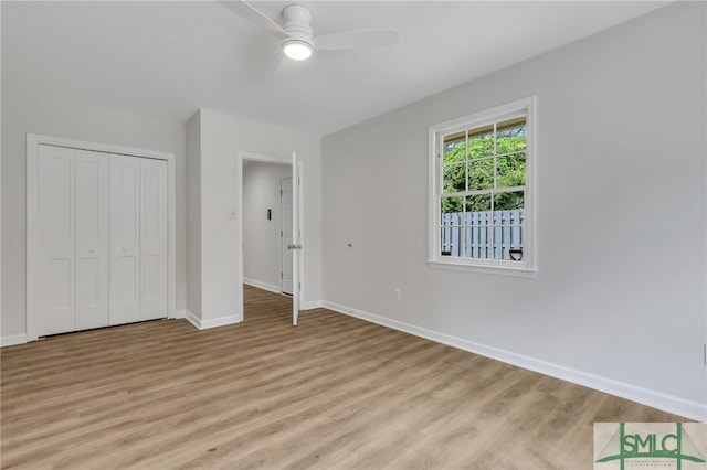 unfurnished bedroom with ceiling fan, a closet, and light hardwood / wood-style floors