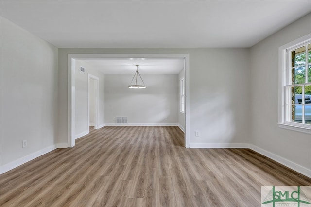 empty room with hardwood / wood-style flooring