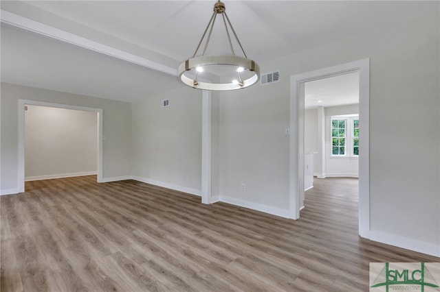 unfurnished room featuring wood-type flooring