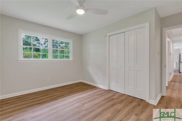 unfurnished bedroom featuring a closet, ceiling fan, and light hardwood / wood-style flooring