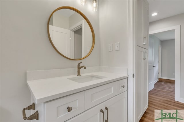 bathroom with vanity and hardwood / wood-style flooring