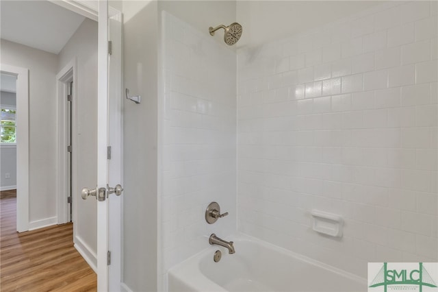 bathroom with tiled shower / bath combo and wood-type flooring