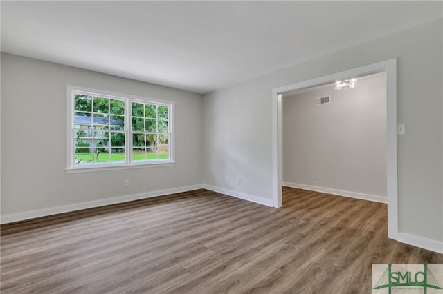 unfurnished room featuring hardwood / wood-style flooring