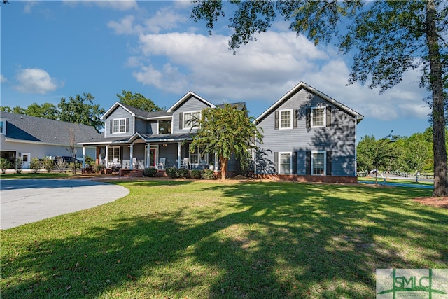 view of front of house with covered porch and a front lawn