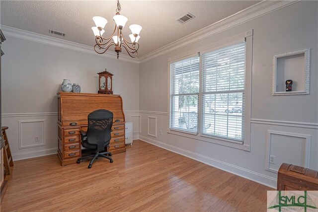 office space with a textured ceiling, an inviting chandelier, crown molding, and light hardwood / wood-style flooring