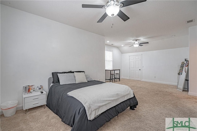 bedroom featuring light colored carpet, visible vents, vaulted ceiling, and baseboards