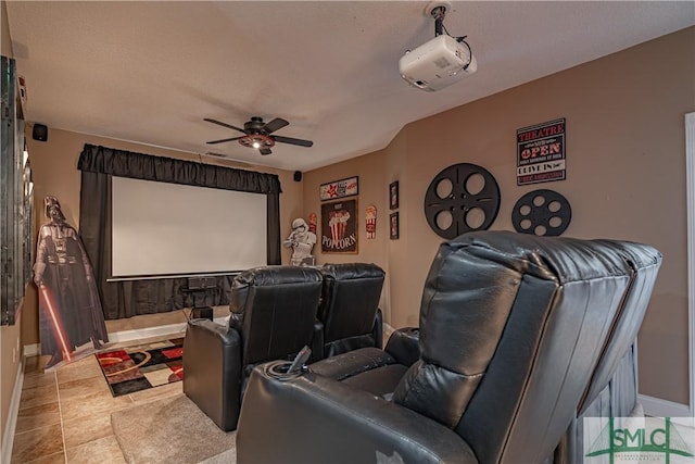 cinema with a ceiling fan and baseboards