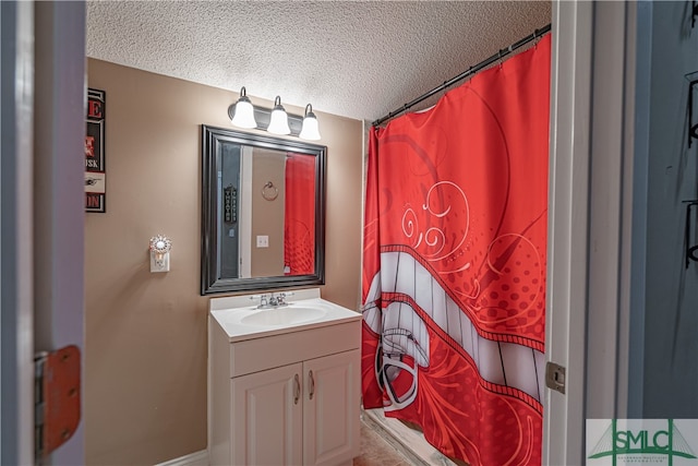 bathroom featuring a shower with curtain, a textured ceiling, and vanity