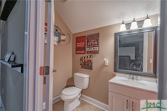 bathroom with toilet, tile patterned flooring, vanity, a textured ceiling, and lofted ceiling