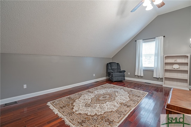 sitting room featuring ceiling fan, dark hardwood / wood-style floors, a textured ceiling, and vaulted ceiling