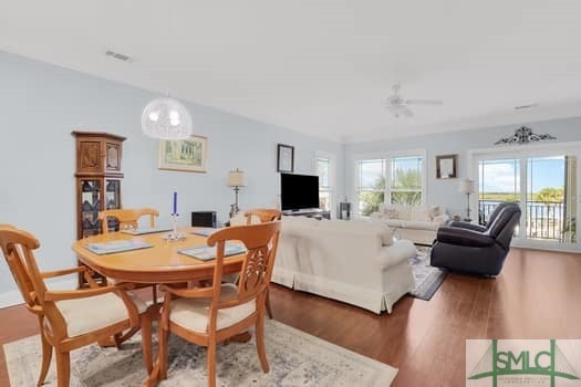 dining area with visible vents, wood finished floors, and a ceiling fan