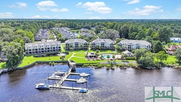 bird's eye view with a water view and a forest view