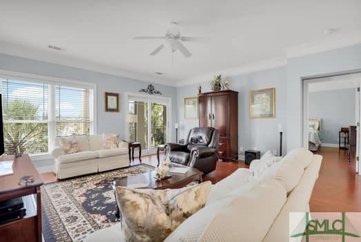 living room featuring ceiling fan and wood finished floors