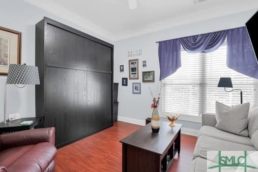 living area with wood finished floors and baseboards