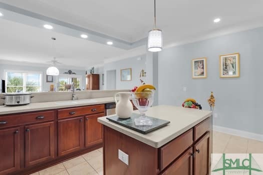 kitchen with light countertops, a sink, decorative light fixtures, and recessed lighting