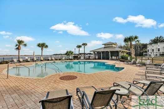 community pool featuring a patio area and fence