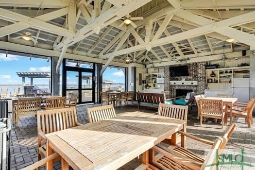 sunroom / solarium featuring ceiling fan, an outdoor brick fireplace, and lofted ceiling