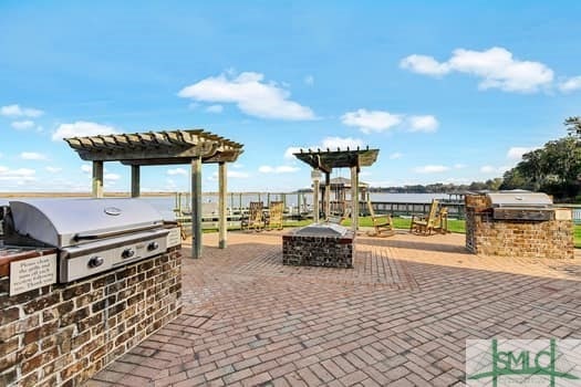 view of patio with a fire pit, area for grilling, and a pergola