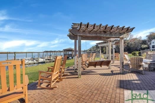 view of patio / terrace with a water view and a pergola