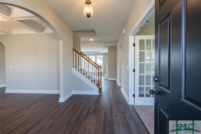 entryway featuring dark hardwood / wood-style flooring, coffered ceiling, and beamed ceiling