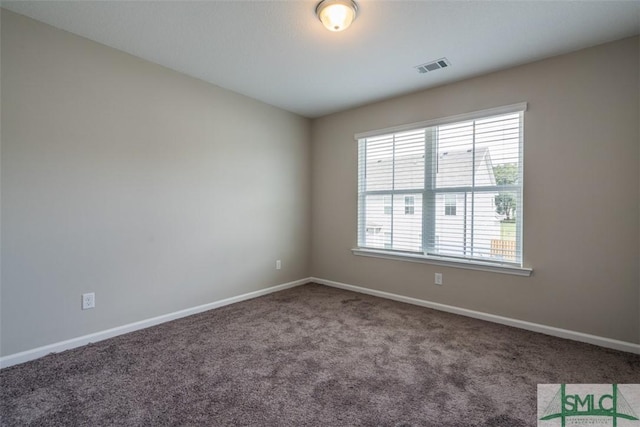 carpeted empty room with visible vents and baseboards