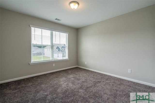 carpeted empty room featuring visible vents and baseboards