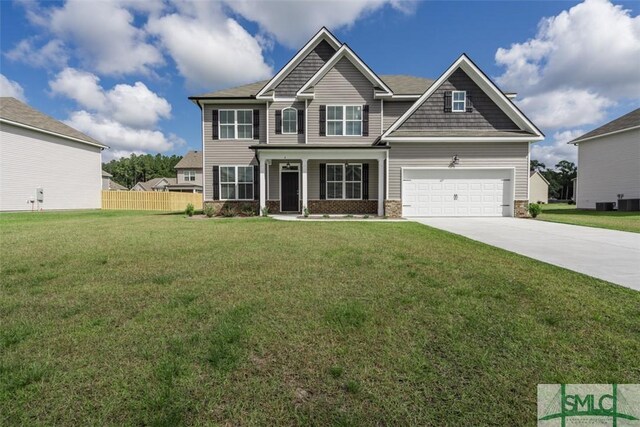 craftsman-style house featuring a garage and a front yard