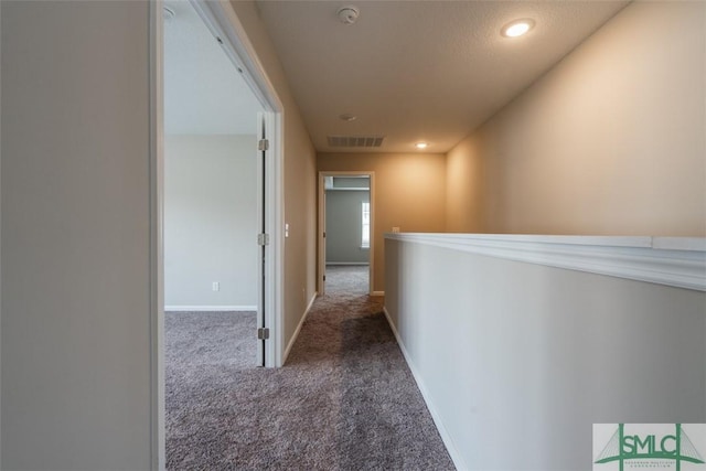 hallway featuring baseboards, visible vents, carpet flooring, and recessed lighting