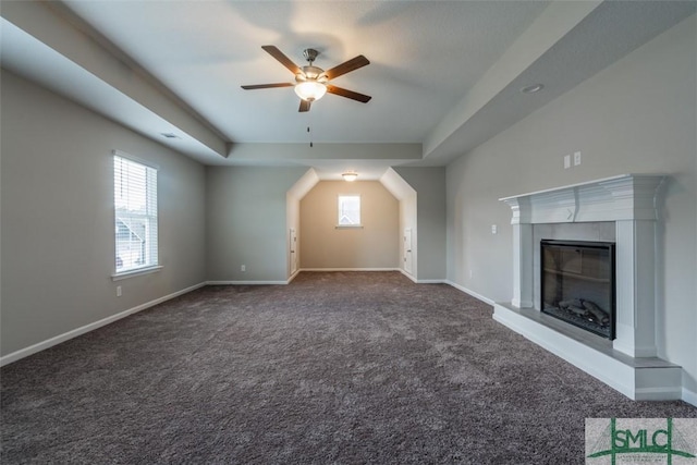 bonus room with a wealth of natural light, carpet, a glass covered fireplace, and baseboards