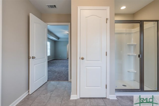 full bath with tile patterned flooring, visible vents, a shower stall, and baseboards