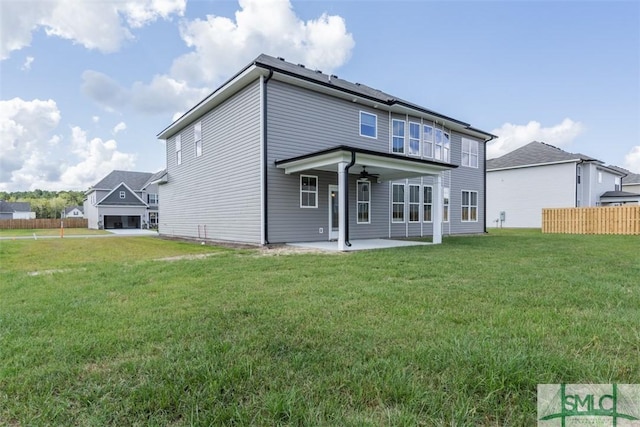 back of house featuring a ceiling fan, a lawn, fence, and a patio