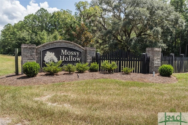 community / neighborhood sign with fence and a lawn