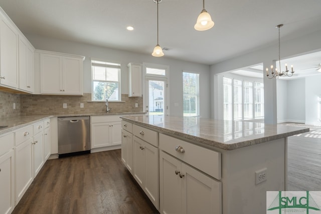 kitchen with white cabinetry, a center island, stainless steel dishwasher, dark hardwood / wood-style floors, and decorative light fixtures