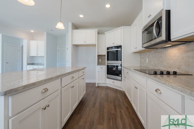 kitchen featuring white cabinetry, dark hardwood / wood-style flooring, stainless steel appliances, and decorative light fixtures