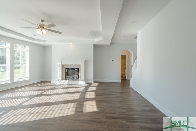 unfurnished living room featuring dark hardwood / wood-style floors and ceiling fan