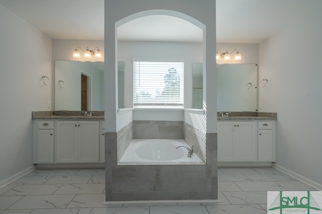 bathroom with a relaxing tiled tub and vanity