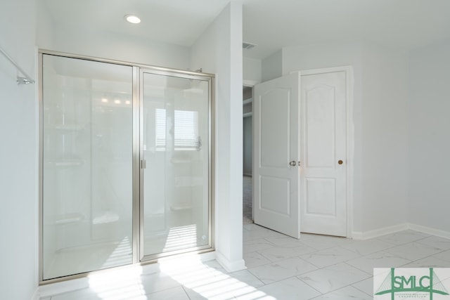 bathroom featuring a shower with shower door