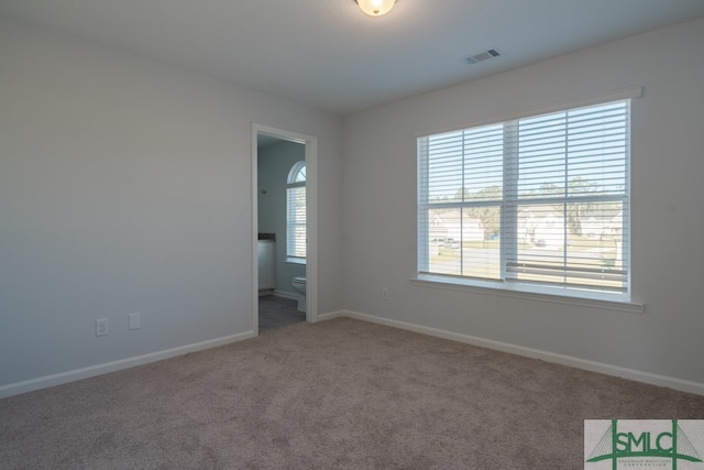 empty room featuring carpet and a healthy amount of sunlight