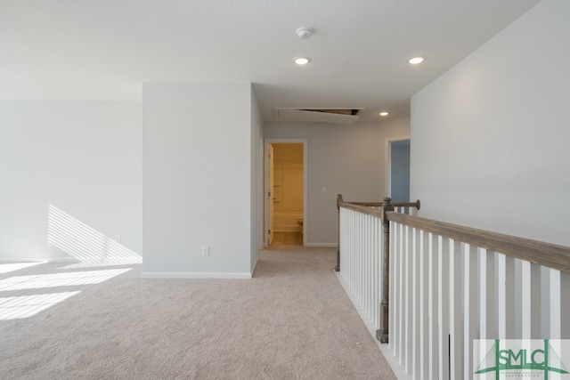 hall featuring light colored carpet