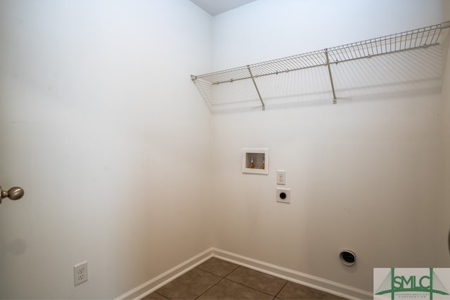 clothes washing area featuring washer hookup, hookup for an electric dryer, and dark tile patterned floors