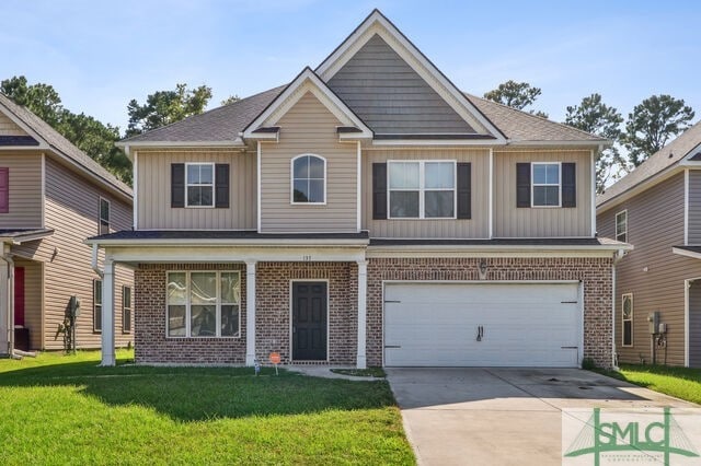 view of front of home featuring a garage and a front yard