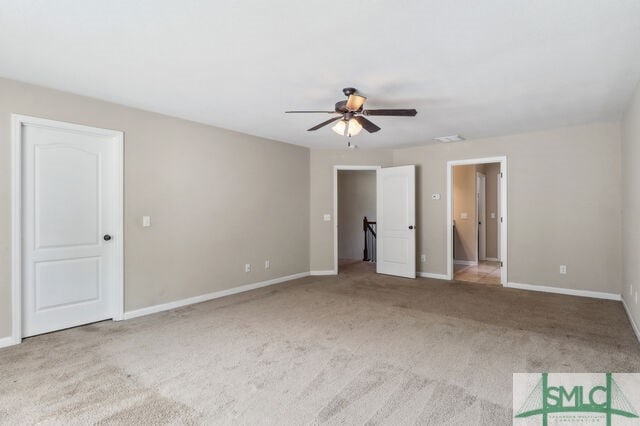 unfurnished bedroom featuring light colored carpet and ceiling fan