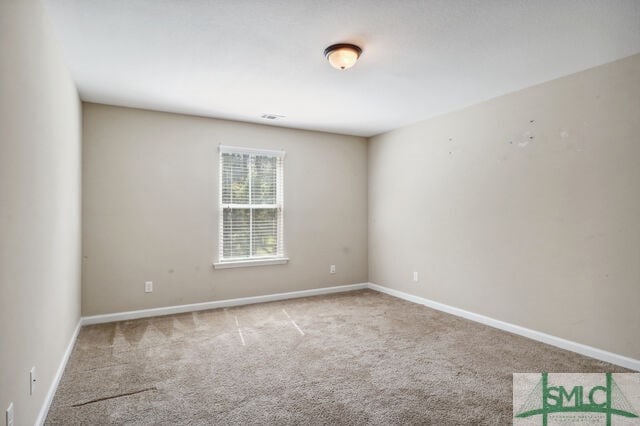 unfurnished room featuring carpet