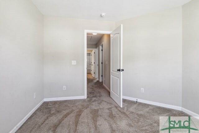 unfurnished room featuring light carpet