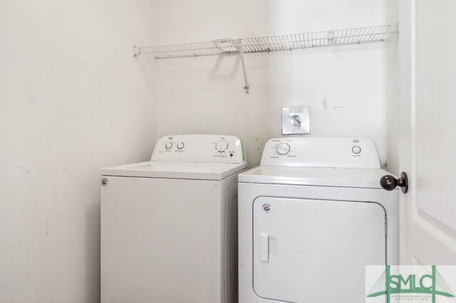 clothes washing area featuring washer and dryer