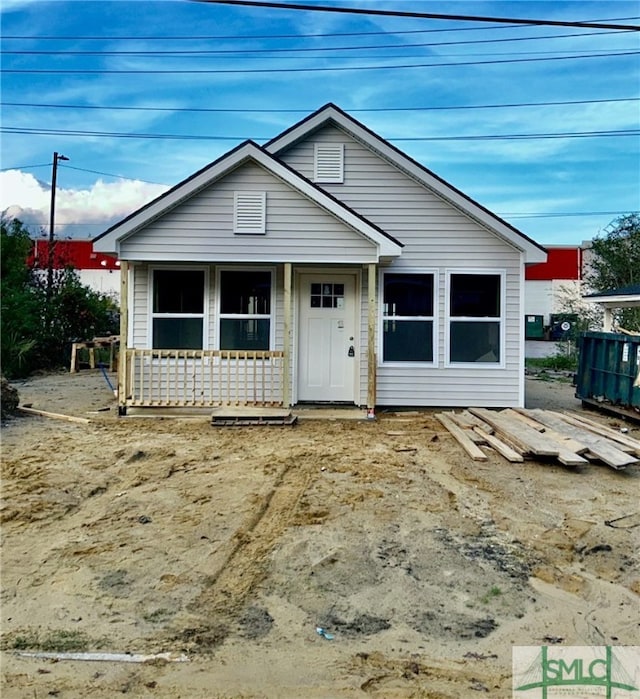 bungalow featuring a porch and central air condition unit